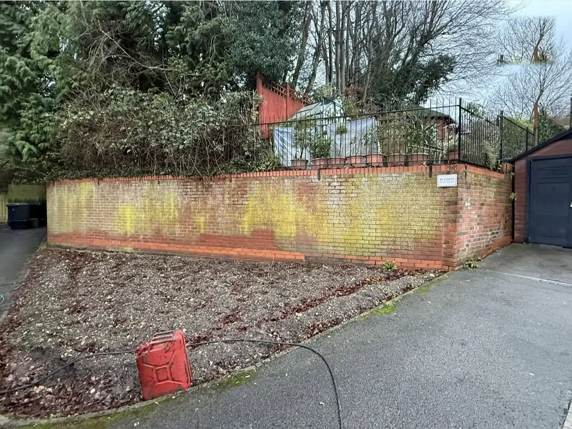 Brick wall cleaning by Geyserclean in Milton Keynes, before treatment