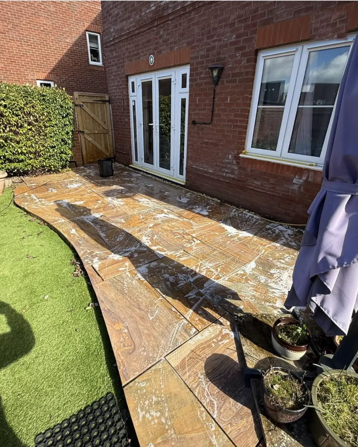 Patio cleaning by Geyserclean in Milton Keynes, work in progress